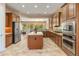 Gourmet kitchen with island, stainless appliances, granite counters and abundant cabinet space at 26473 W Runion Ln, Buckeye, AZ 85396
