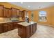 Kitchen features a central island, granite countertops, and stainless steel appliances at 26473 W Runion Ln, Buckeye, AZ 85396