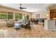 Open living space with a ceiling fan, comfortable seating and access to the patio at 26473 W Runion Ln, Buckeye, AZ 85396