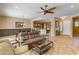 Bright living area with an open layout, ceiling fan, comfortable seating, and backyard view at 26473 W Runion Ln, Buckeye, AZ 85396