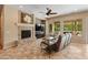 Spacious living room featuring a fireplace, ceiling fan and lots of natural light at 26473 W Runion Ln, Buckeye, AZ 85396