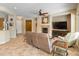 Bright living room with fireplace and ceiling fan, seamlessly connected to other living spaces at 26473 W Runion Ln, Buckeye, AZ 85396