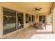 Covered patio with full outdoor furniture set and desert landscaping at 26473 W Runion Ln, Buckeye, AZ 85396