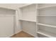 Well-organized walk-in closet with shelving and hanging rods for optimal storage at 26473 W Runion Ln, Buckeye, AZ 85396