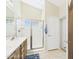 Bright bathroom with a glass-enclosed shower, single vanity, and a tall vaulted ceiling at 28942 N Lazurite Way, San Tan Valley, AZ 85143