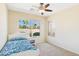 Cozy bedroom featuring a single bed, a bright window with palm tree views, and neutral walls with carpet at 28942 N Lazurite Way, San Tan Valley, AZ 85143
