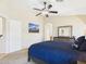 Comfortable bedroom with neutral carpet, ceiling fan and ensuite bathroom at 28942 N Lazurite Way, San Tan Valley, AZ 85143