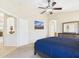 Comfortable bedroom with neutral carpet, ceiling fan and ensuite bathroom at 28942 N Lazurite Way, San Tan Valley, AZ 85143