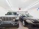 Clean garage with two parked vehicles, bright overhead lighting, and an automatic garage door opener at 28942 N Lazurite Way, San Tan Valley, AZ 85143