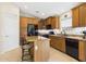 Functional kitchen with an island, dark appliances, and ample storage space at 28942 N Lazurite Way, San Tan Valley, AZ 85143