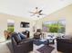 Spacious living room with a ceiling fan, large windows and neutral color tones, creating a comfortable ambiance at 28942 N Lazurite Way, San Tan Valley, AZ 85143