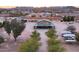 Aerial view of the ranch home with a long driveway, surrounding trees, and an expansive outdoor space at 29756 N Varnum Rd, San Tan Valley, AZ 85143