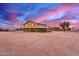 Lovely two-story home showcasing wraparound porch, set on a spacious lot under a stunning sky at 29756 N Varnum Rd, San Tan Valley, AZ 85143