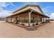 Large building with covered porch and landscaped grounds, perfect for entertaining at 29756 N Varnum Rd, San Tan Valley, AZ 85143