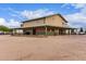Large unique building exterior, featuring a covered porch and a vast dirt yard at 29756 N Varnum Rd, San Tan Valley, AZ 85143