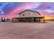 Beautiful two-story home with wraparound porch under vibrant sunset sky at 29756 N Varnum Rd, San Tan Valley, AZ 85143