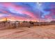 Horse property with large outdoor arena, surrounded by multiple horses at 29756 N Varnum Rd, San Tan Valley, AZ 85143