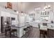 Bright, modern kitchen with white cabinetry, granite countertops, and a center island with seating at 29756 N Varnum Rd, San Tan Valley, AZ 85143
