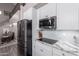 Modern kitchen with stainless appliances, marble countertops and sleek white cabinets at 29756 N Varnum Rd, San Tan Valley, AZ 85143