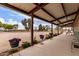 Relaxing patio with seating and potted plants, overlooking a spacious yard at 29756 N Varnum Rd, San Tan Valley, AZ 85143