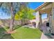 A serene backyard featuring lush artificial grass, a covered patio, and a seating area, ideal for outdoor relaxation at 30430 N 42Nd Pl, Cave Creek, AZ 85331