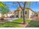 Backyard featuring a lush green lawn and a covered patio with outdoor seating area, perfect for relaxation and entertaining at 30430 N 42Nd Pl, Cave Creek, AZ 85331