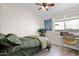 Cozy bedroom with a ceiling fan, window, and stylish decor at 30430 N 42Nd Pl, Cave Creek, AZ 85331