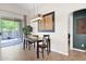 Bright dining area features stylish light fixture, large windows, and access to the patio at 30430 N 42Nd Pl, Cave Creek, AZ 85331