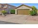 A well-maintained home exterior featuring a two-car garage, landscaped front yard, and a neatly paved driveway at 30430 N 42Nd Pl, Cave Creek, AZ 85331