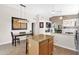 Open floor plan with kitchen, dining area, and a view to the living area with fireplace at 30430 N 42Nd Pl, Cave Creek, AZ 85331