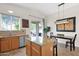 Open kitchen with a granite island, stainless steel dishwasher, and a dining area at 30430 N 42Nd Pl, Cave Creek, AZ 85331