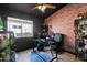Office featuring a brick accent wall, glass desk and large window at 30430 N 42Nd Pl, Cave Creek, AZ 85331