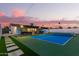 Beautiful backyard featuring a tennis court, covered patio with furniture, and stone pathway at 3209 E Marilyn Rd, Phoenix, AZ 85032
