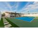 Beautiful backyard featuring a tennis court, covered patio with furniture, and stone pathway at 3209 E Marilyn Rd, Phoenix, AZ 85032