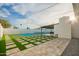 An expansive backyard space features a tennis court, outdoor dining, stone patio and covered patio at 3209 E Marilyn Rd, Phoenix, AZ 85032