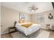 Bright bedroom featuring a ceiling fan, a window with blinds, and neutral-colored walls at 3209 E Marilyn Rd, Phoenix, AZ 85032