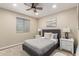 Bedroom featuring a tufted headboard, ceiling fan, window with blinds, and hardwood floors at 3209 E Marilyn Rd, Phoenix, AZ 85032