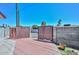 Gated backyard entrance featuring brick-paved area and mature trees offering shade and privacy at 3328 S Stanley Pl, Tempe, AZ 85282