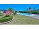 Beautiful backyard featuring a sparkling pool, lush green lawn, and mature landscaping at 3328 S Stanley Pl, Tempe, AZ 85282