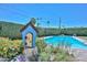 Picturesque backyard with a sparkling pool, mature trees, and quaint garden décor at 3328 S Stanley Pl, Tempe, AZ 85282