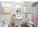 Traditional bathroom with a claw-foot tub, pedestal sink, and wainscoting at 3328 S Stanley Pl, Tempe, AZ 85282