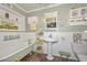 Charming bathroom featuring a claw-foot tub, pedestal sink, and decorative elements at 3328 S Stanley Pl, Tempe, AZ 85282