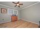 Neutral-toned bedroom with hardwood floors, a dresser, and a double-hung window at 3328 S Stanley Pl, Tempe, AZ 85282