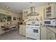 Bright kitchen features a vintage stove, an eat-in breakfast nook, and tiled floors at 3328 S Stanley Pl, Tempe, AZ 85282