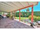 Serene covered patio with tiled flooring, lush greenery, and view of the expansive backyard at 3328 S Stanley Pl, Tempe, AZ 85282
