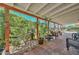 Spacious covered patio with tile flooring, seating, garden view, and mature landscaping at 3328 S Stanley Pl, Tempe, AZ 85282