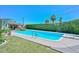 View of backyard swimming pool with clear blue water and green, manicured lawn at 3328 S Stanley Pl, Tempe, AZ 85282