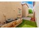 Backyard with pavers and artificial turf near AC units and wooden planters at 3591 S Ranger Trl, Gilbert, AZ 85297