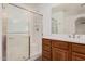 Bathroom showcasing shower with glass doors and a wood vanity with modern fixtures at 3591 S Ranger Trl, Gilbert, AZ 85297