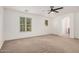 Bedroom features carpet, arched doorway, and large windows providing ample natural light at 3591 S Ranger Trl, Gilbert, AZ 85297